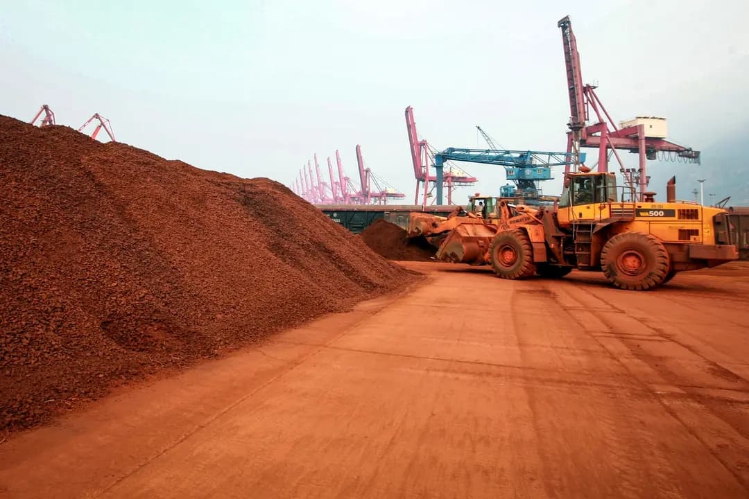 Un hombre conduce una pala cargadora para trasladar tierra que contiene minerales de tierras raras para su exportación a Japón en un puerto de Lianyungang, provincia de Jiangsu, China, el 5 de septiembre de 2010. China tiene el monopolio casi absoluto de la industria de las tierras raras, desde la extracción y el refinado hasta la fabricación de imanes. (STR/AFP a través de Getty Images)