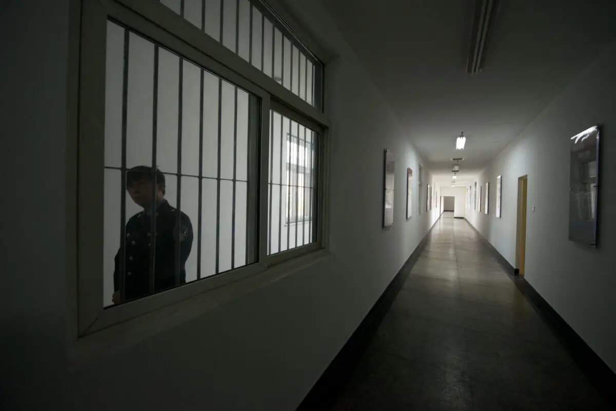 Un guardia mira a través de la ventana de un pasillo dentro de un centro de detención en Beijing, China, el 25 de octubre de 2012. (Ed Jones/AFP a través de Getty Images)