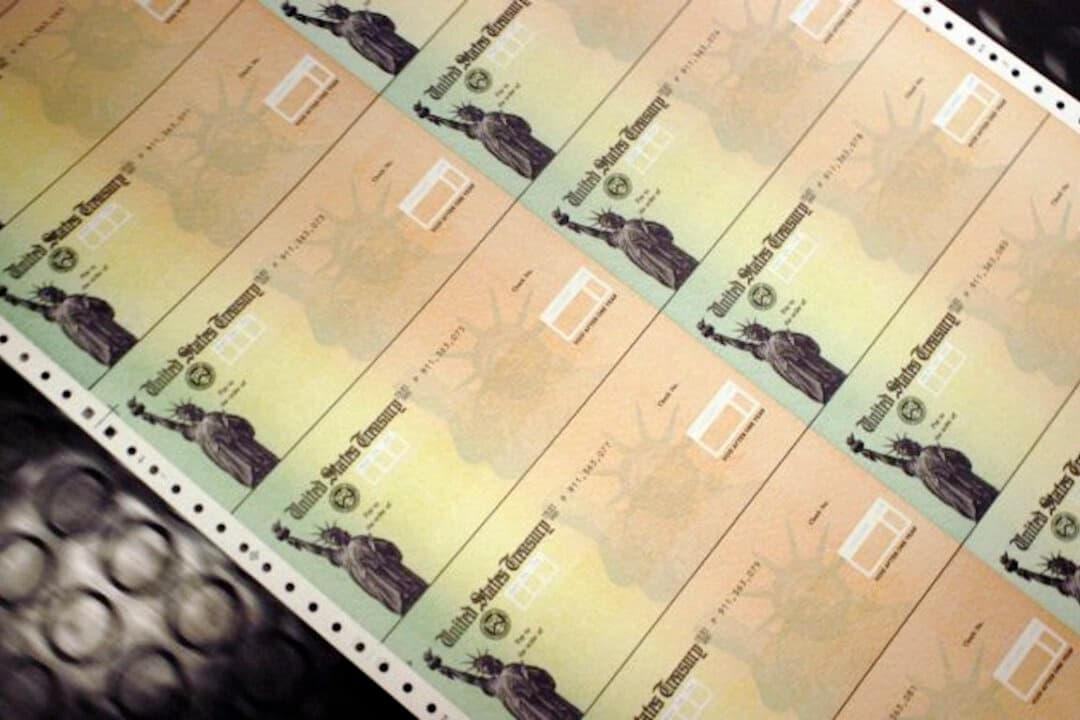 Cheques en blanco del Seguro Social pasan por una impresora en las instalaciones del Departamento del Tesoro de EE. UU. en Filadelfia, Pensilvania, el 18 de julio de 2011. (William Thomas Cain/Getty Images)
