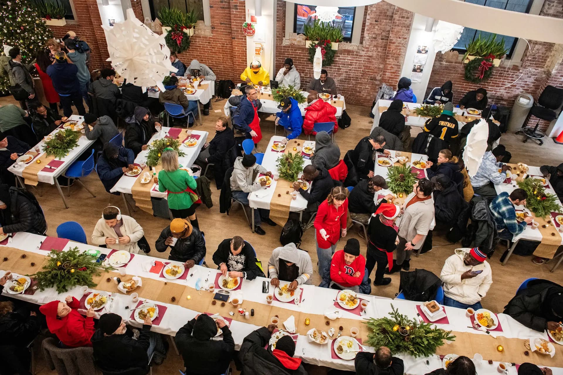 Personas comen sus alimentos en St. Francis House, el refugio diurno más grande de Nueva Inglaterra, el día de Navidad en Boston, el 25 de diciembre de 2025. Según un censo de 2025 realizado por la ciudad, hay 2,122 adultos solteros que experimentan situación de calle. Joseph Prezioso/AFP vía Getty Images