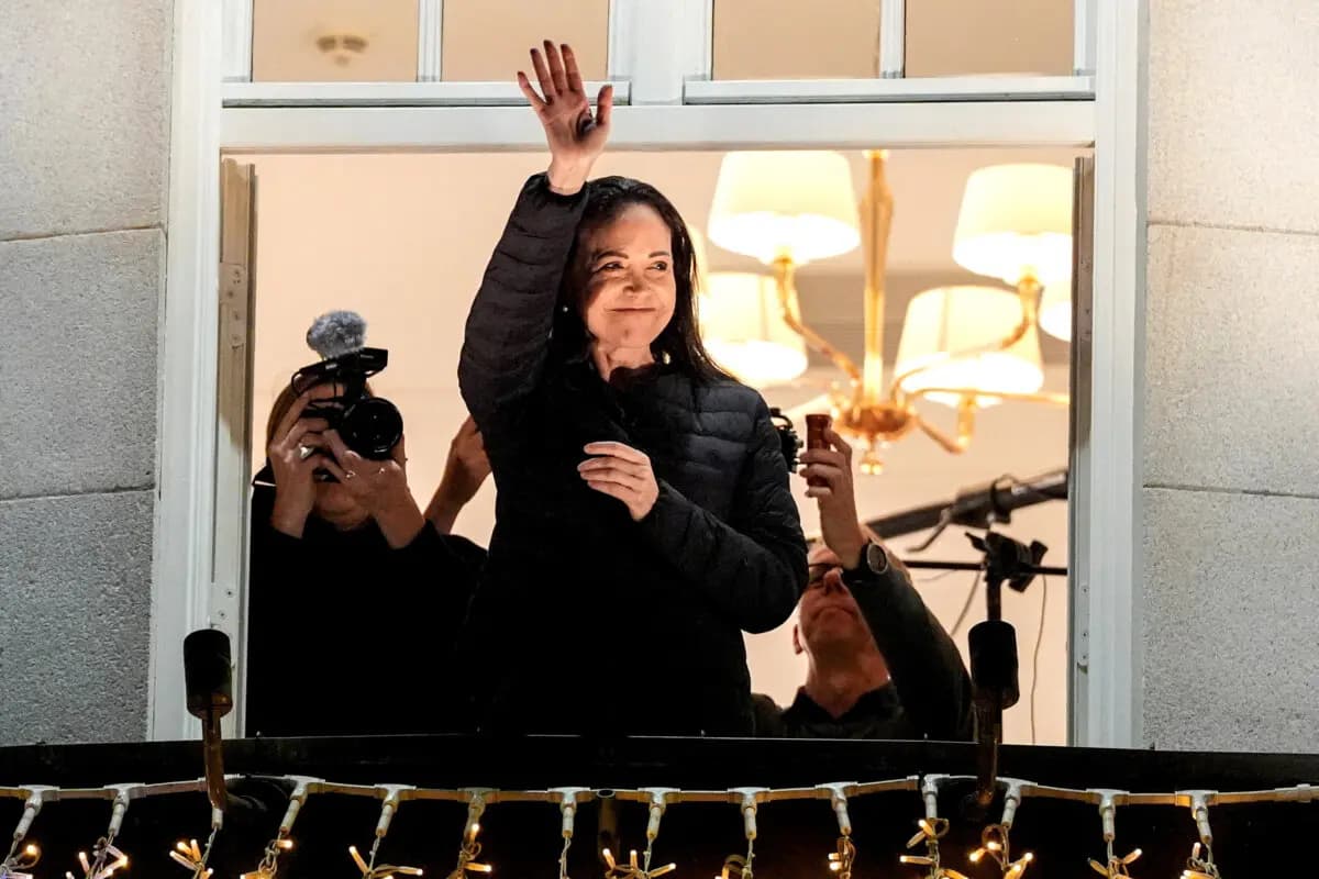 <em>La ganadora del Premio Nobel de la Paz, María Corina Machado, saluda desde el balcón del Grand Hotel de Oslo, Noruega, el 11 de diciembre de 2025. (Lise Aserud/NTB vía Reuters)</em>