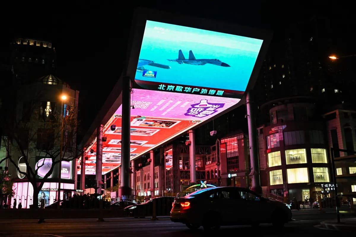 Vista general de una pantalla gigante pública que transmite noticias sobre los ejercicios militares de China alrededor de Taiwán, fuera de un centro comercial en Beijing el 1 de abril de 2025. (Adek Berry/AFP vía Getty Images)