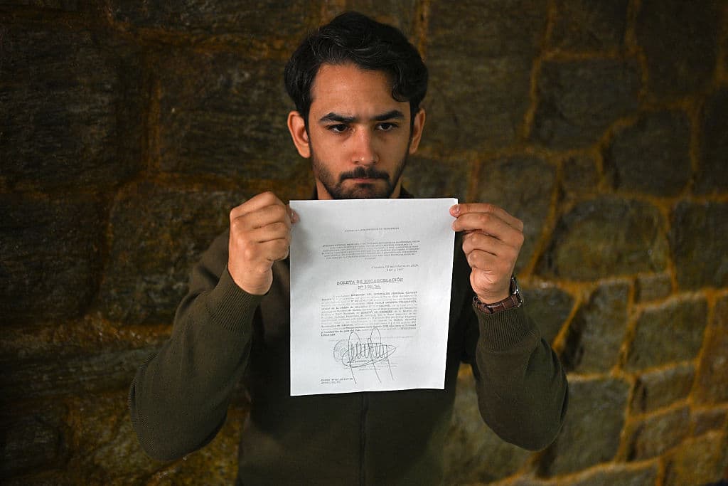 <em>Ramón Guanipa, hijo del ex vicepresidente de la Asamblea Nacional Juan Pablo Guanipa, muestra el documento de liberación durante una rueda de prensa tras la nueva detención de su padre en Caracas el 9 de febrero de 2026. (Federico PARRA / AFP vía Getty Images)</em>