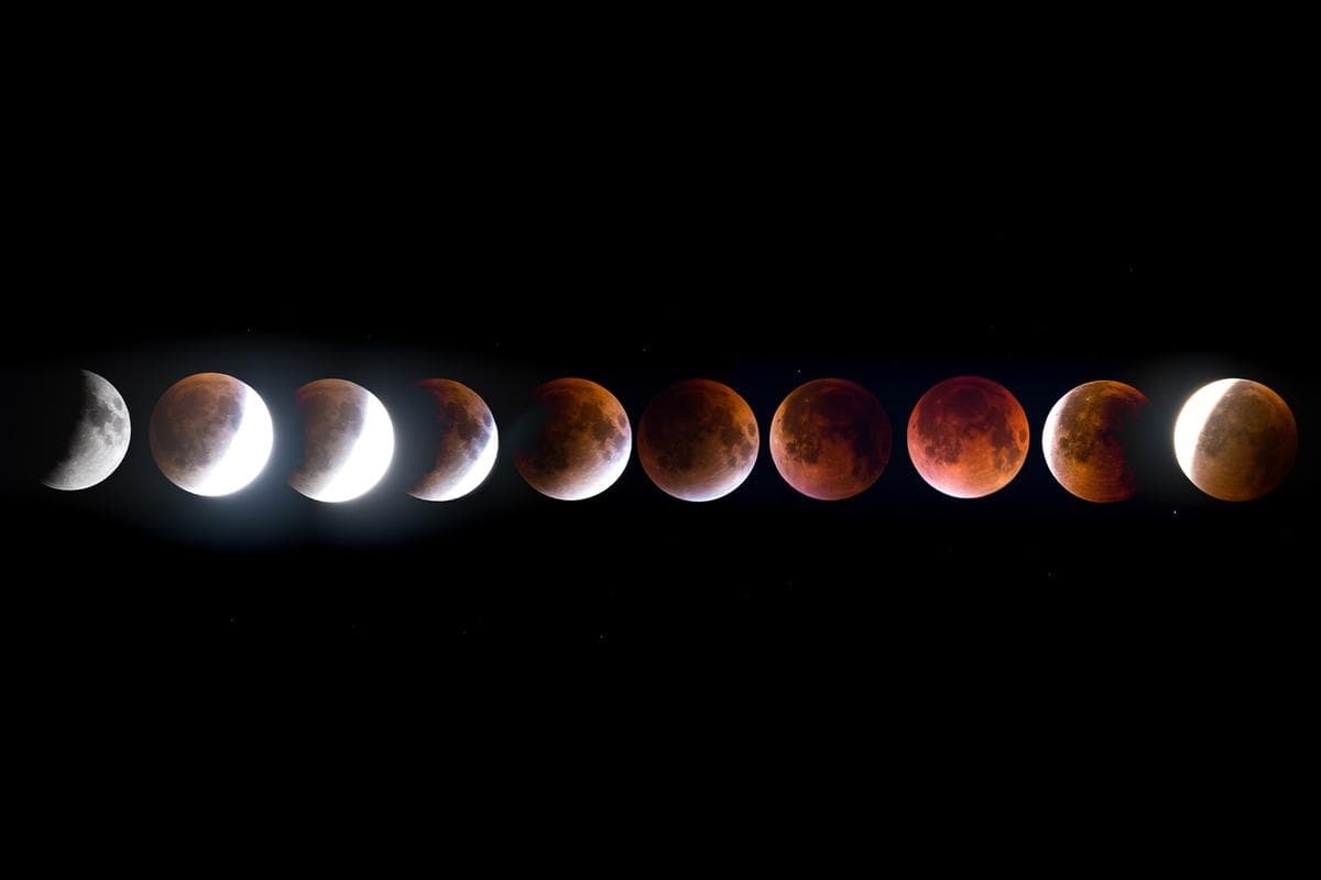Ilustración de un eclipse lunar total entrando en la fase de totalidad, que lo hace brillar en rojo debido a la luz solar refractada a través de la atmósfera terrestre. (Shutterstock/Shubhajit Roy Karmakar)