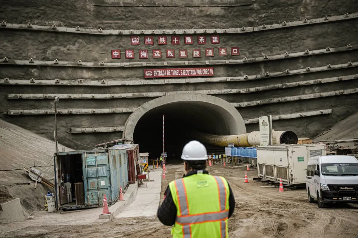 <em>Un trabajador enfrente de la entrada de un túnel en el sitio donde la empresa china Cosco Shipping construye un puerto en Chancay, a unos 80 kilómetros al norte de Lima, el 22 de agosto de 2023. (Ernesto Benavides/AFP vía Getty Images)</em>