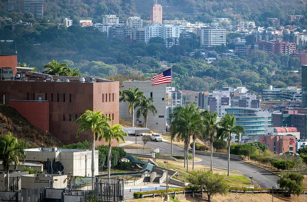 <em>La bandera estadounidense ondea en la embajada de Estados Unidos en Caracas el 14 de marzo de 2026, diez días después del restablecimiento de las relaciones diplomáticas tras la captura del derrocado líder Nicolás Maduro en una incursión militar estadounidense. (Maryorin Méndez / AFP vía Getty Images)</em>