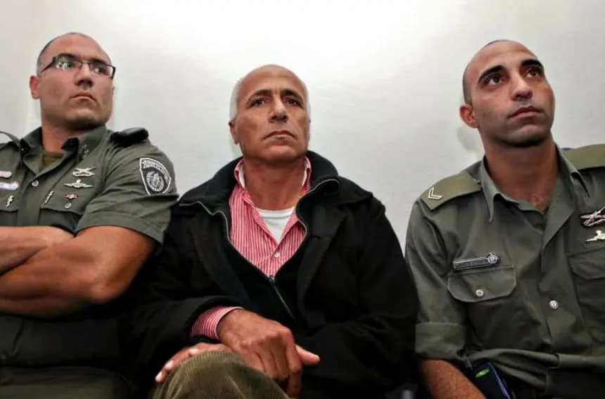 El denunciante nuclear israelí, Mordechai Vanunu, sentado entre policías israelíes en un tribunal de Jerusalén, el 29 de diciembre de 2009. (Gali Tibbon/AFP/Getty Images)