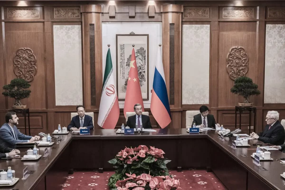 El ministro de Asuntos Exteriores chino, Wang Yi (C), preside una reunión con el viceministro de Asuntos Exteriores ruso, Sergei Ryabkov (D), y el viceministro de Asuntos Exteriores iraní, Kazem Gharibabadi (I), durante un encuentro celebrado en Beijing el 14 de marzo de 2025. (Stringer/Getty Images)