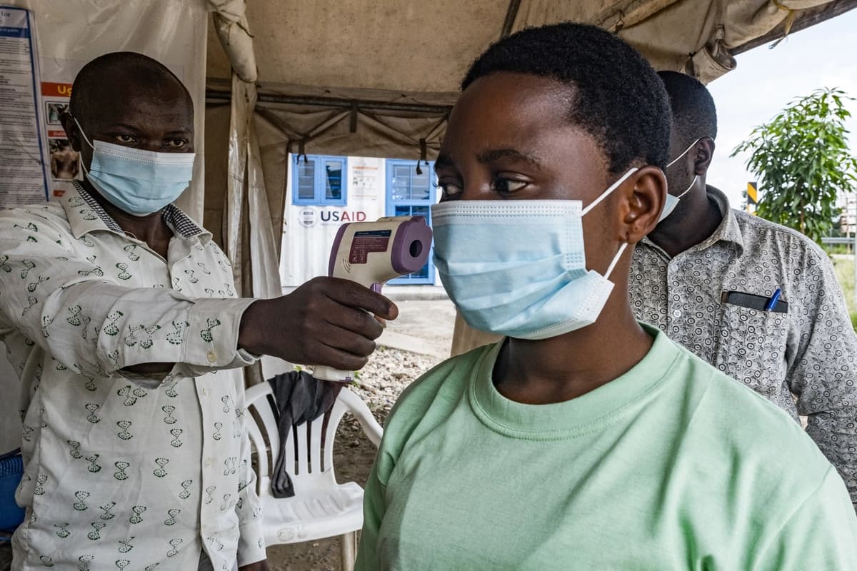 <em>Una autoridad de salud en el paso fronterizo de Busunga, entre Uganda y la República Democrática del Congo, toma la temperatura a un viajero en Bundibugyo el 18 de mayo de 2026. (Badru Katumba/AFP vía Getty Images).</em>
