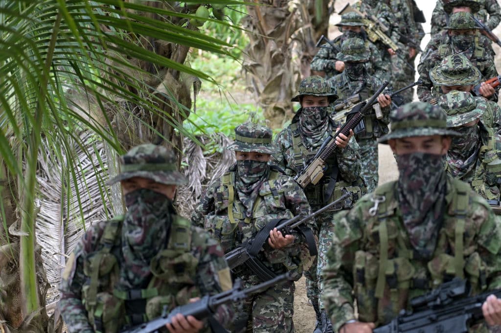 Miembros del grupo disidente Segunda Marquetalia, perteneciente a las FARC, marchan en una finca de Llorente, zona rural de la ciudad portuaria de Tumaco, departamento de Nariño, Colombia, el 31 de agosto de 2024. Menos de tres meses después de haber iniciado conversaciones de paz con el gobierno, uno de los grupos rebeldes de izquierda más grandes de Colombia dijo que las negociaciones están "bloqueadas" y acusa al gobierno del presidente Gustavo Petro de no cumplir con sus principales demandas.  (Foto de JOAQUIN SARMIENTO/AFP vía Getty Images)