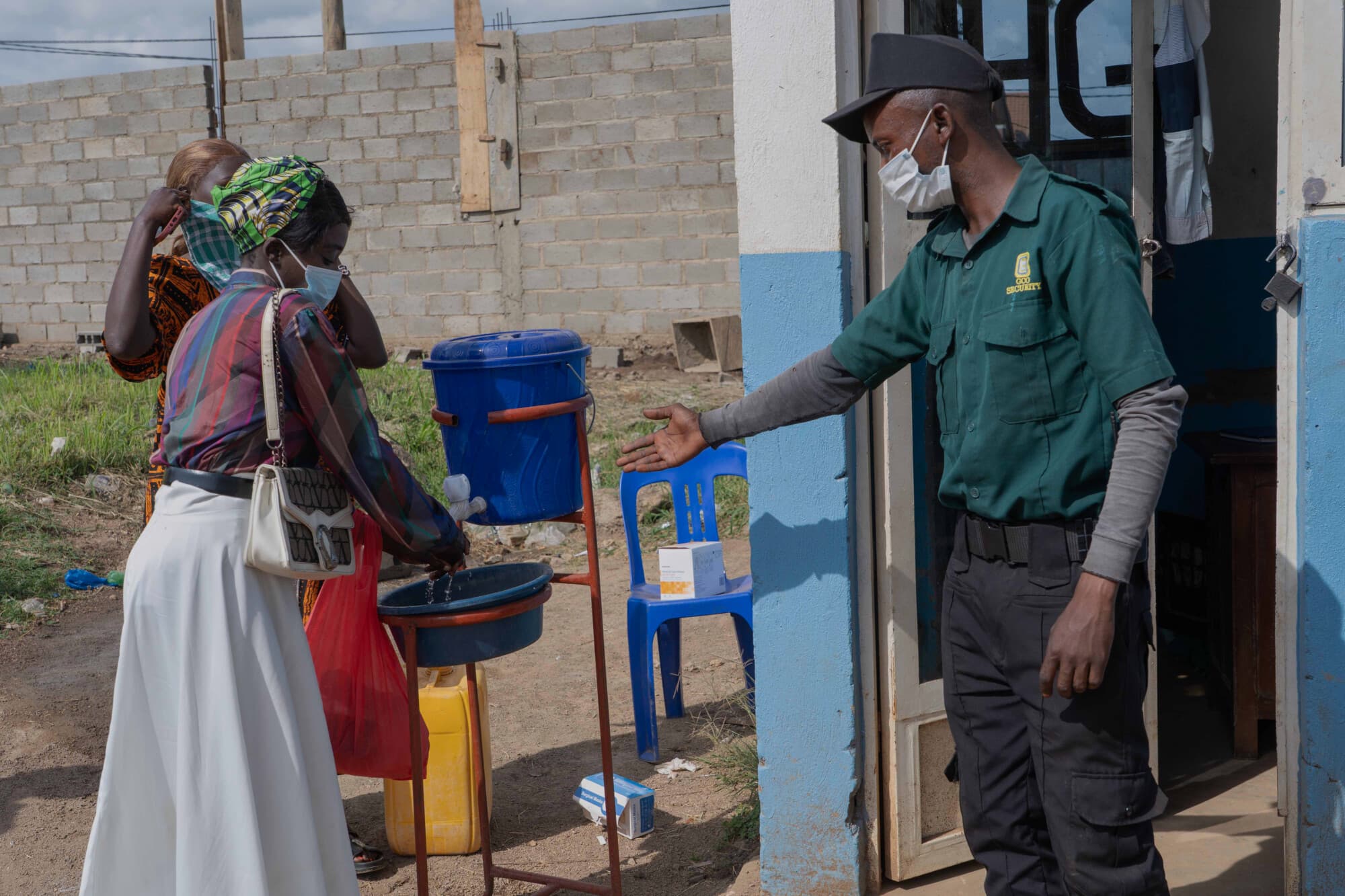 People wash their hands at the entrance to a hospital in Bunia, Congo, Sunday, May 17, 2026. (AP Photo/ Dirole Lotsima Dieudonne)