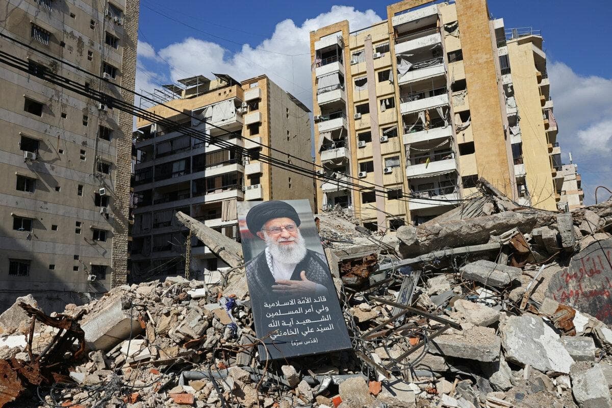 Esta fotografía, tomada durante una visita de prensa organizada por la oficina de comunicación de Hezbolá, muestra una pancarta con una imagen del difunto líder supremo iraní, el ayatolá Alí Jamenei, colocada entre los escombros de un edificio destruido cerca del complejo Sayyid al-Shuhada, en los suburbios del sur de Beirut, el 6 de mayo de 2026. (Anwar Amro/ AFP vía Getty Images)
