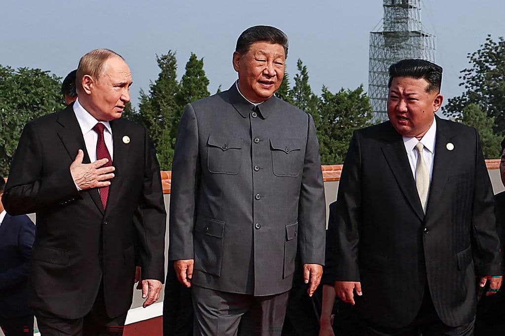 TOPSHOT - In this pool photograph distributed by the Russian state agency Sputnik, (L-R) Russia's President Vladimir Putin walks with China's President Xi Jinping and North Korea's leader Kim Jong Un before a military parade marking the 80th anniversary of victory over Japan and the end of World War II, in Beijing's Tiananmen Square on September 3, 2025. (Photo by Alexander KAZAKOV / POOL / AFP via Getty Images)