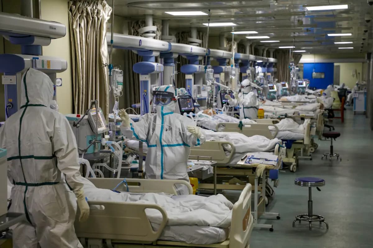 Personal sanitario con trajes de protección atiende a pacientes con COVID-19 en la unidad de cuidados intensivos (UCI) de un hospital designado durante el brote de la enfermedad por coronavirus (COVID-19) en Wuhan, provincia de Hubei (China), el 6 de febrero de 2020. (China Daily vía Reuters)