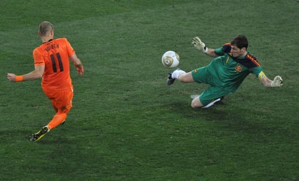 El guardameta español Iker Casillas (derecha) realiza una parada con las piernas a un disparo del delantero neerlandés Arjen Robben durante la final de la Copa Mundial de Fútbol de 2010 en el estadio Soccer City en Soweto, suburbio de Johannesburgo, el 11 de julio de 2010. (ROBERTO SCHMIDT / AFP vía Getty Images)