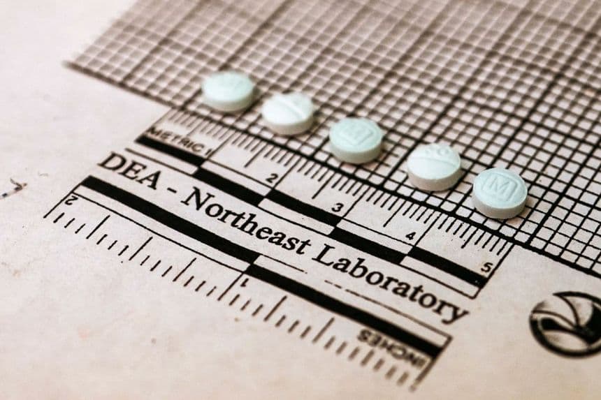 Tabletas sospechosas de contener fentanilo se colocan en un gráfico para medir su tamaño en el Laboratorio Regional del Noreste de la DEA en Nueva York el 8 de octubre de 2019. (Don Emmert/AFP vía Getty Images)