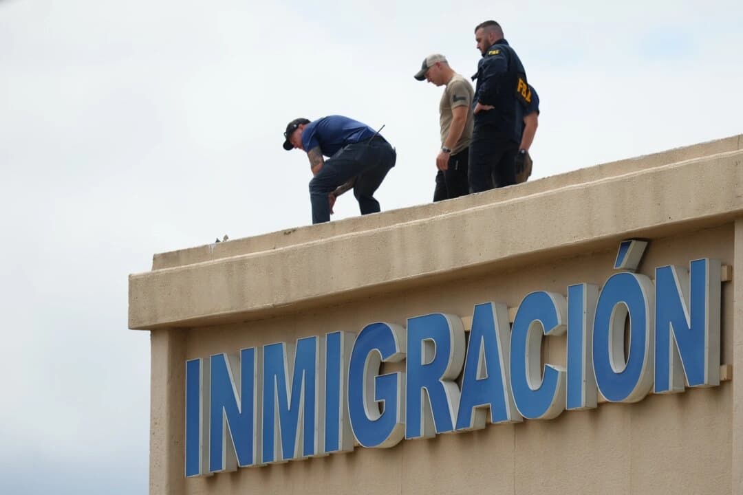 Agentes de las fuerzas del orden inspeccionan el tejado de un edificio cercano al lugar del tiroteo en una oficina del Servicio de Inmigración y Control de Aduanas (ICE) en Dallas el 24 de septiembre de 2025. (Julio Cortez/Foto de AP)