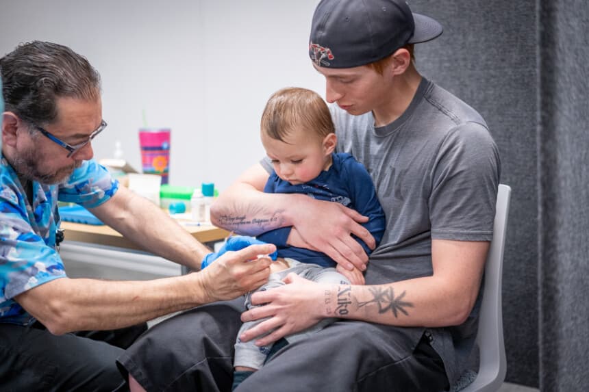 Ethan Turner sostiene a su hijo de 14 meses, Niko, mientras Raynard Covarrubio le administra la vacuna triple vírica en una clínica de vacunación organizada por el Departamento de Salud Pública de Lubbock el 1 de marzo de 2025 en Lubbock, Texas. (Foto de Jan Sonnenmair/Getty Images)