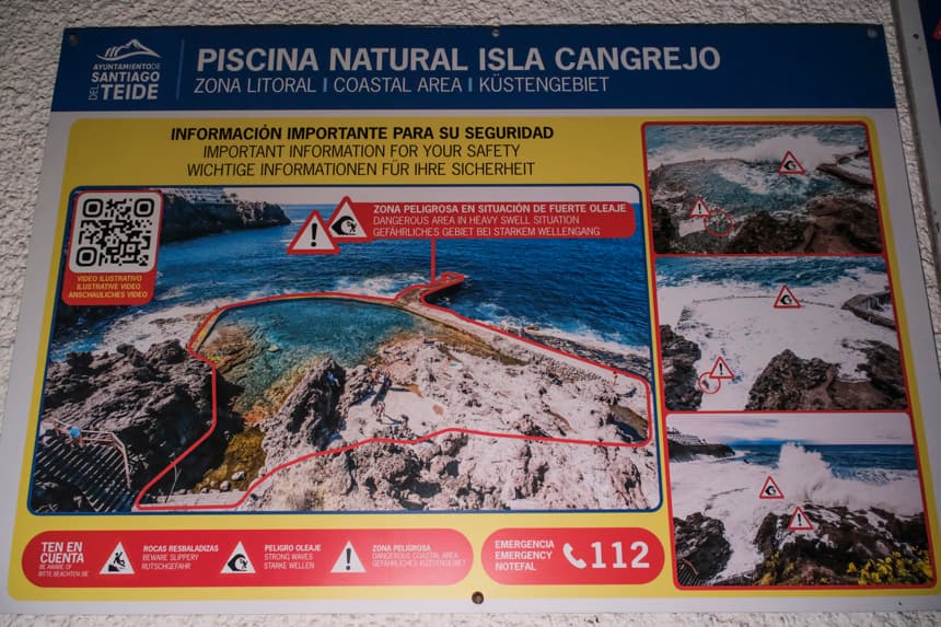 Imagen tomada este domingo del cartel que informa de los peligros con oleaje de la piscina natural de Isla Cangrejo, en Los Gigantes (Tenerife), donde cuatro personas fallecieron esta tarde al ser arrastradas por un golpe de mar. (EFE/Alberto Valdés)