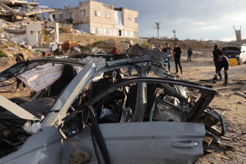 Palestinos inspeccionan el lugar de un ataque israelí contra un automóvil en la Ciudad de Gaza, el 13 de diciembre de 2025. (Omar AL-QATTAA / AFP via Getty Images)