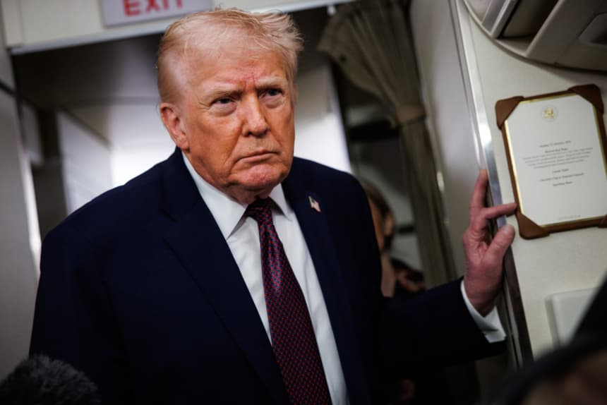 President Donald Trump takes questions from the members of the press aboard Air Force One on January 11, 2026 en route back to the White House from Palm Beach, Florida. (Samuel Corum/Getty Images)