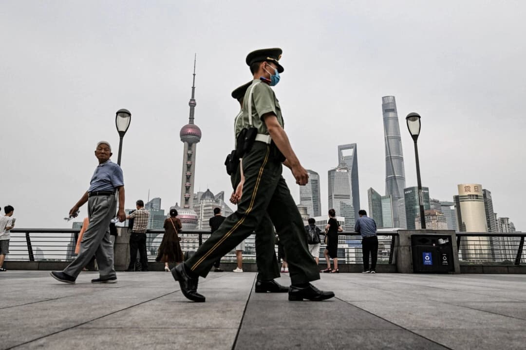 Policía paramilitar china camina por el paseo del Bund a lo largo del río Huangpu en el distrito de Huangpu en Shanghái, China, el 15 de junio de 2023. (Hector Retamal/AFP vía Getty Images)