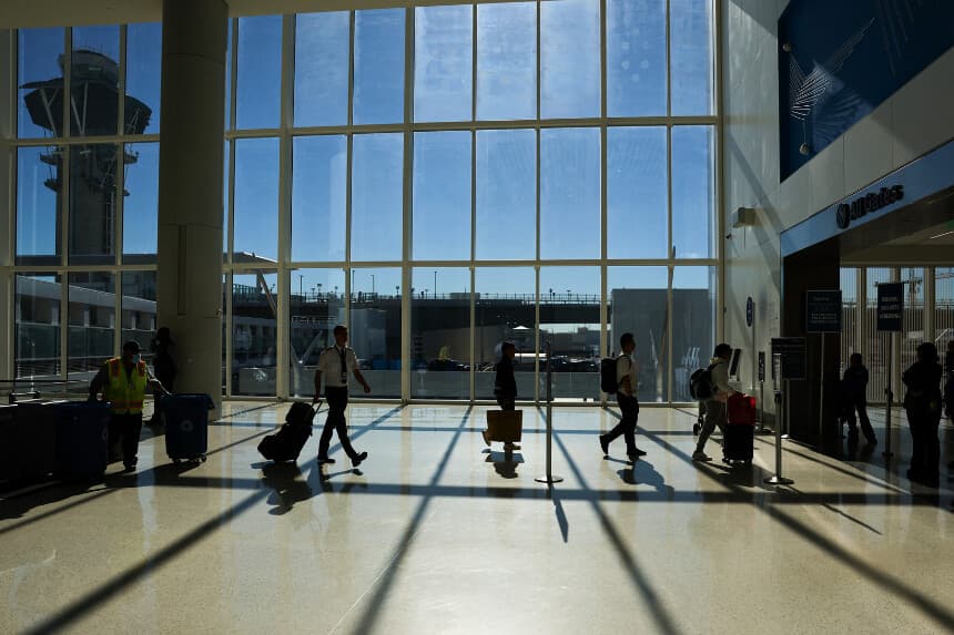 Pasajeros y tripulación se dirigen a un control de seguridad de la Administración de Seguridad en el Transporte (TSA) mientras viajan por el Aeropuerto Internacional de Los Ángeles (LAX) en Los Ángeles, el 26 de noviembre de 2025. (Patrick T. Fallon/AFP a través de Getty Images)